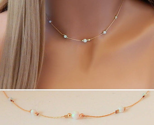 Model wearing a gold choker necklace with 5 opal gemstones that was handmade by Gilded Sapphire.