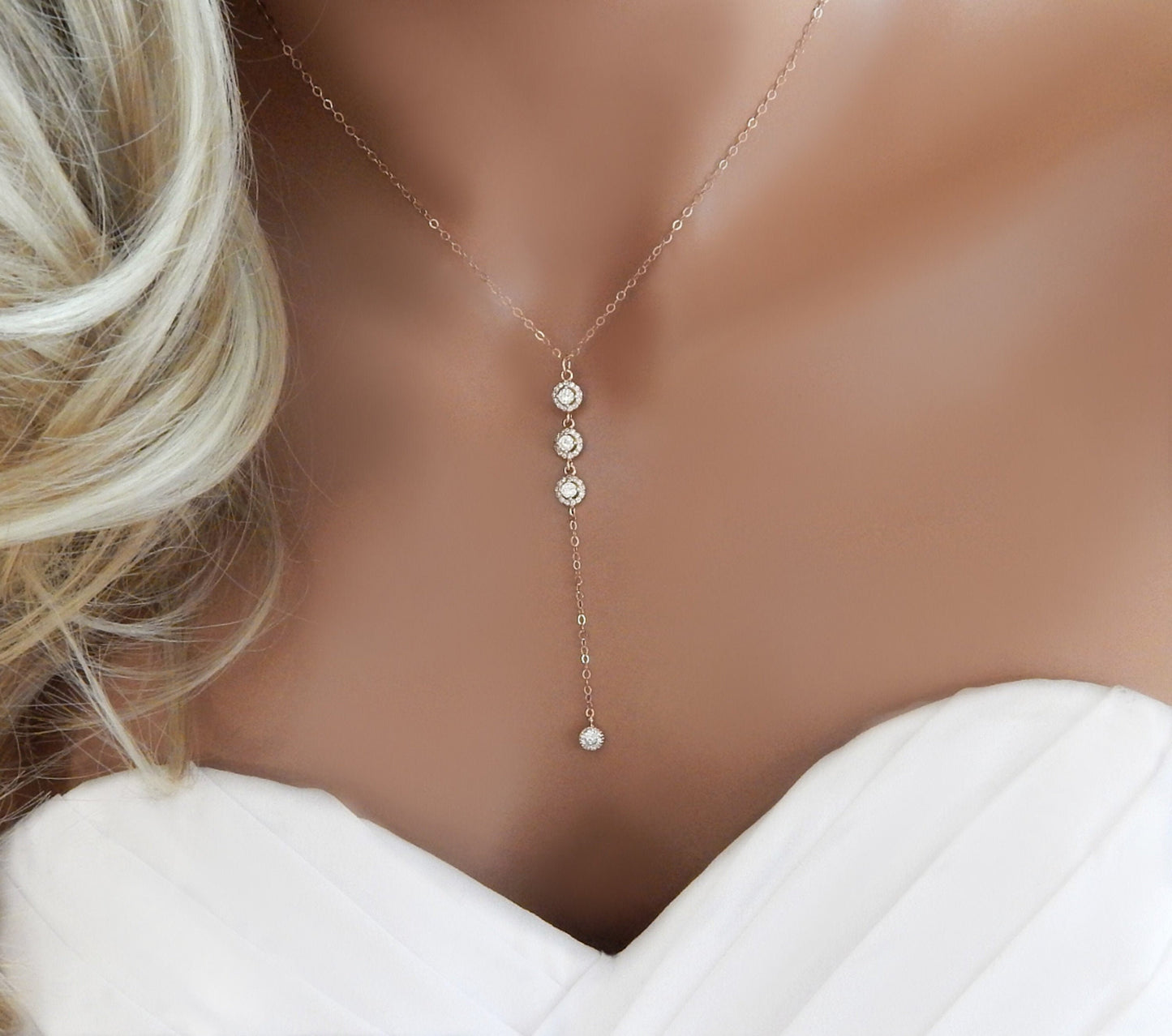 Bridal mannequin torso wearing a gold filled lariat Y necklace with 4 cubic zirconia diamonds.