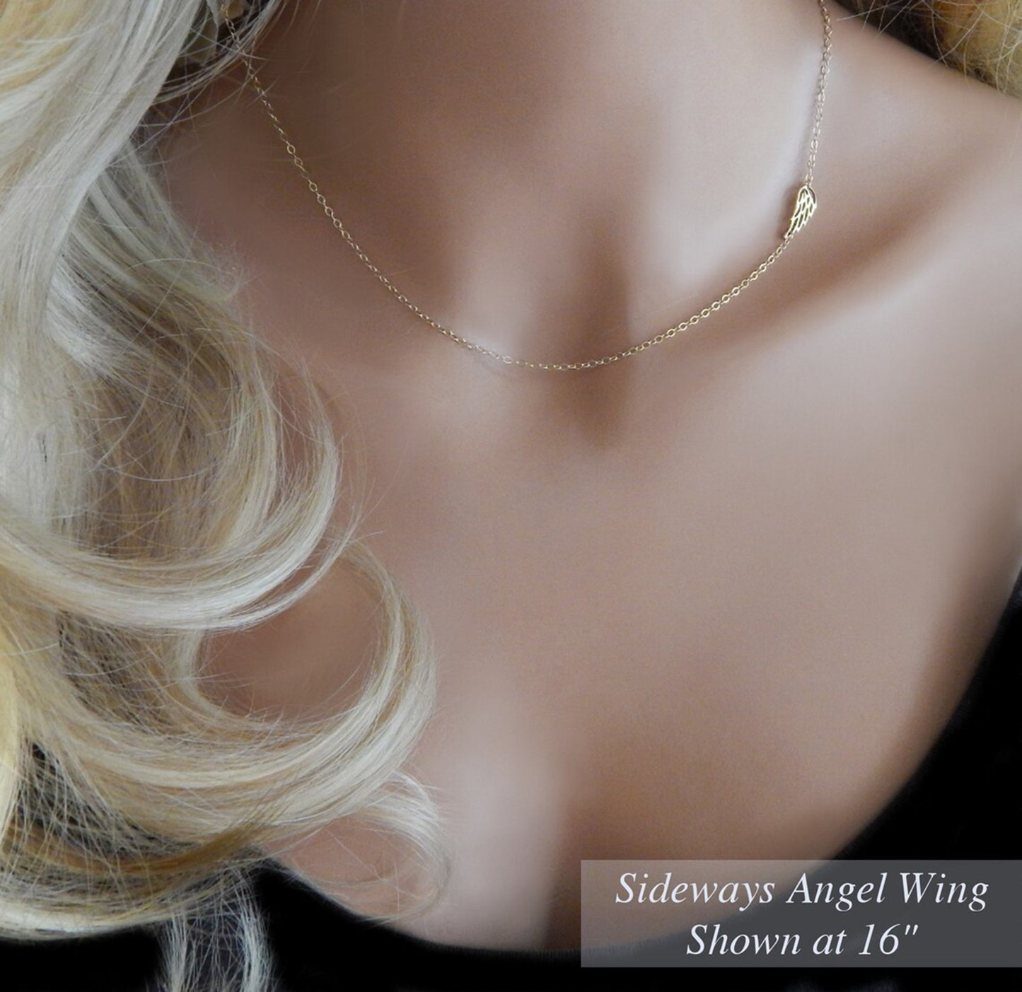 Sentimental dainty gold filled choker with a guardian angel wing charm placed sideways is worn on a mannequin to demonstrate how a 16 inch necklace will fit the average adult woman.