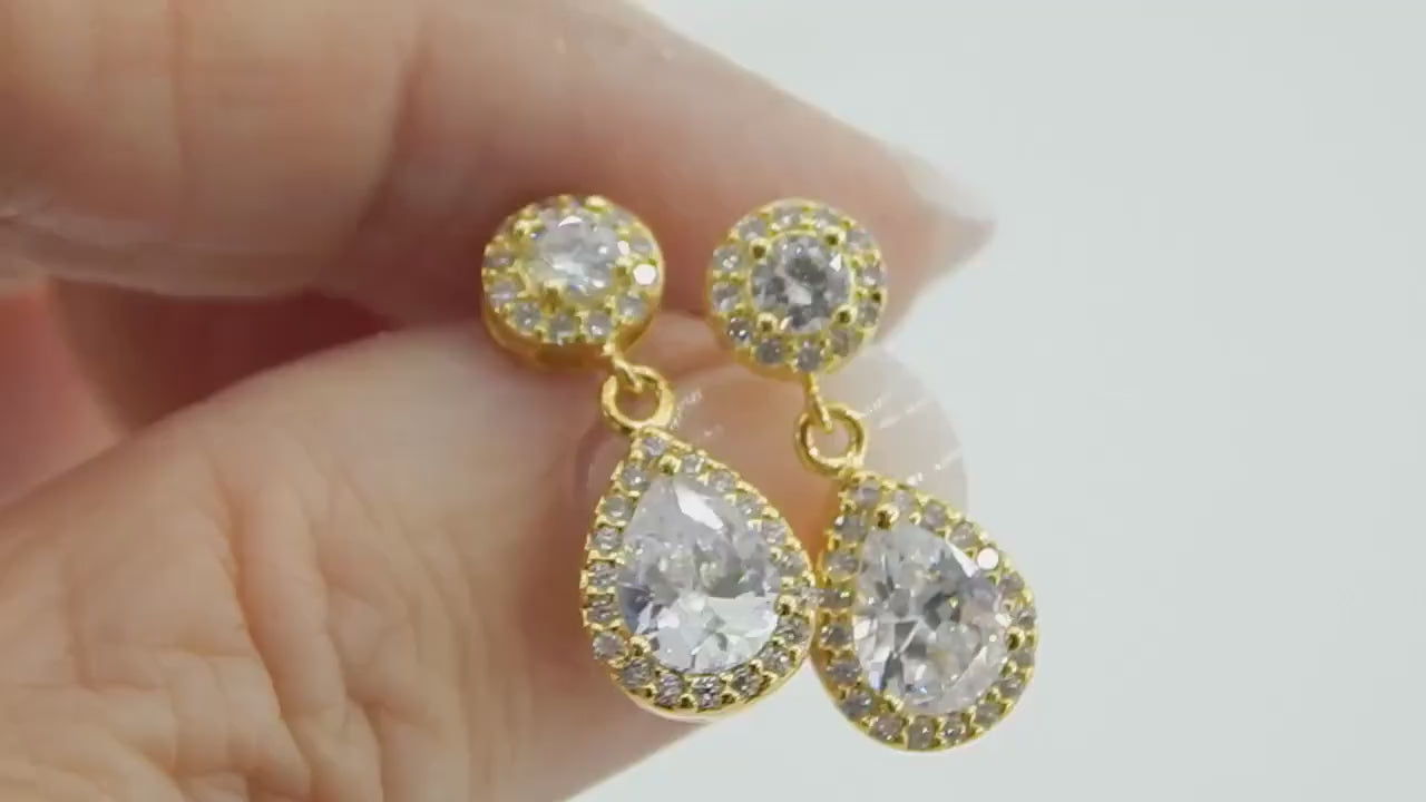 Gold filled earrings with multiple cubic zirconia gemstones are rotated slightly to show how much sparkle these earrings have.