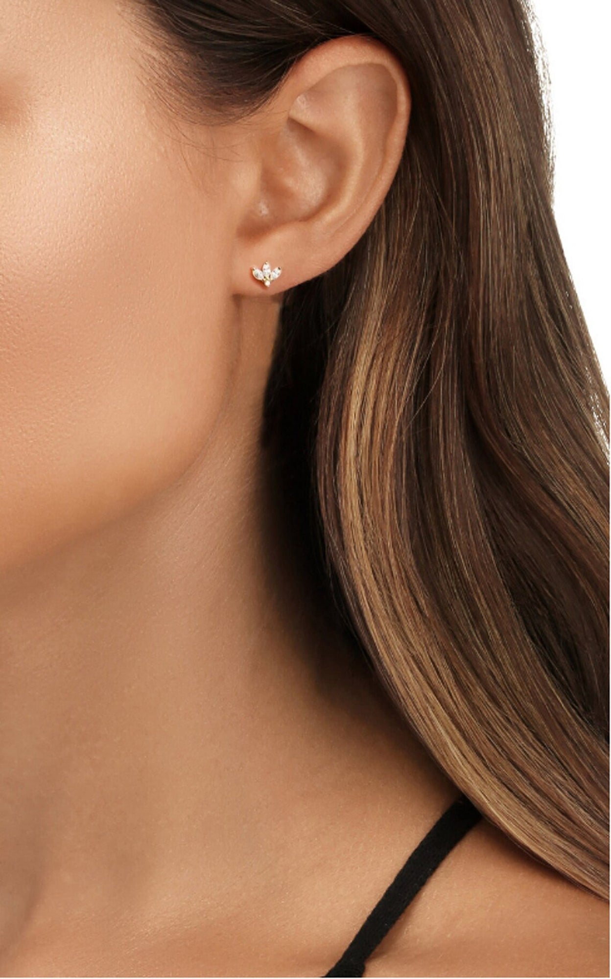 Tan and brunette model turned in a profile view to show off her diamond cz gold stud earrings.