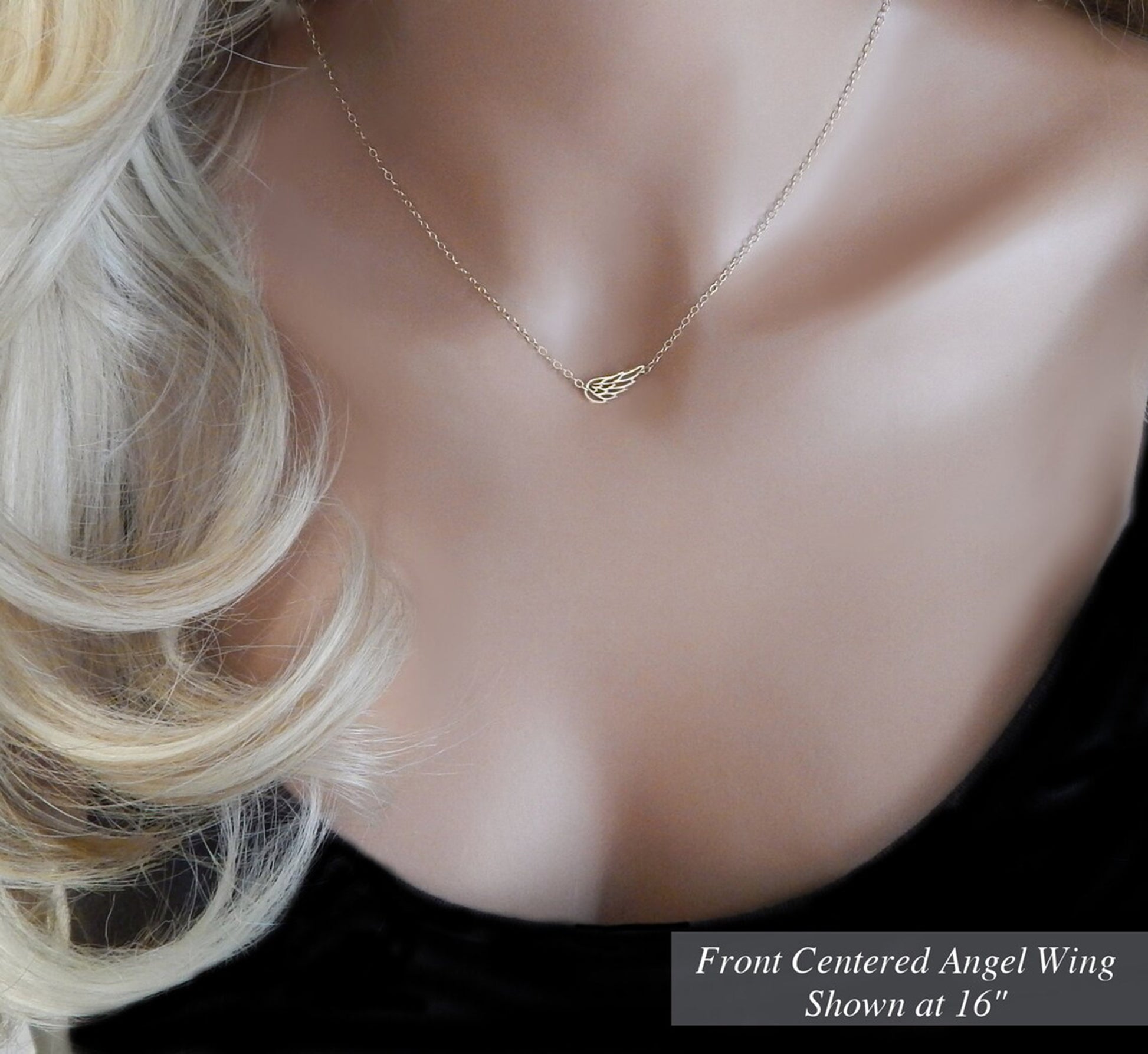 Gold filled guardian angel wing necklace on a dainty cable chain with a sparkle mirror finish is made in a length of 16 inches by the jewelers at Gilded Sapphire and worn on a mannequin to demonstrate how the length will look on the average woman.