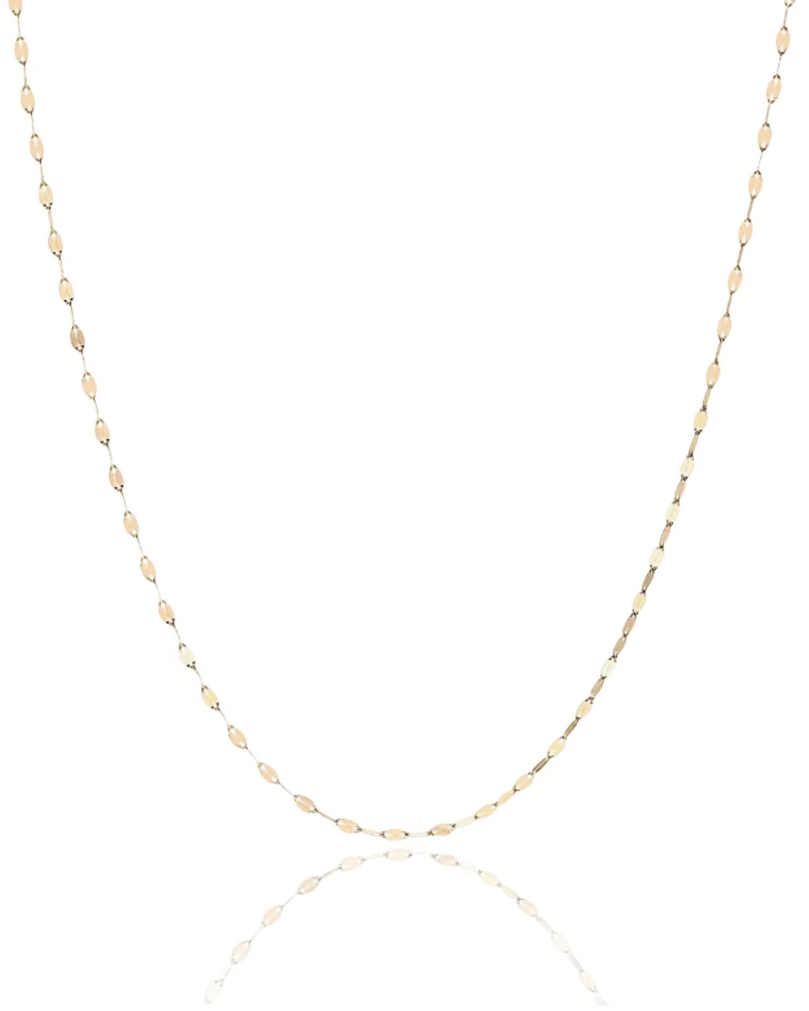 Solid gold necklace chain with sequin links hanging against a blank white background with a reflective surface underneath.
