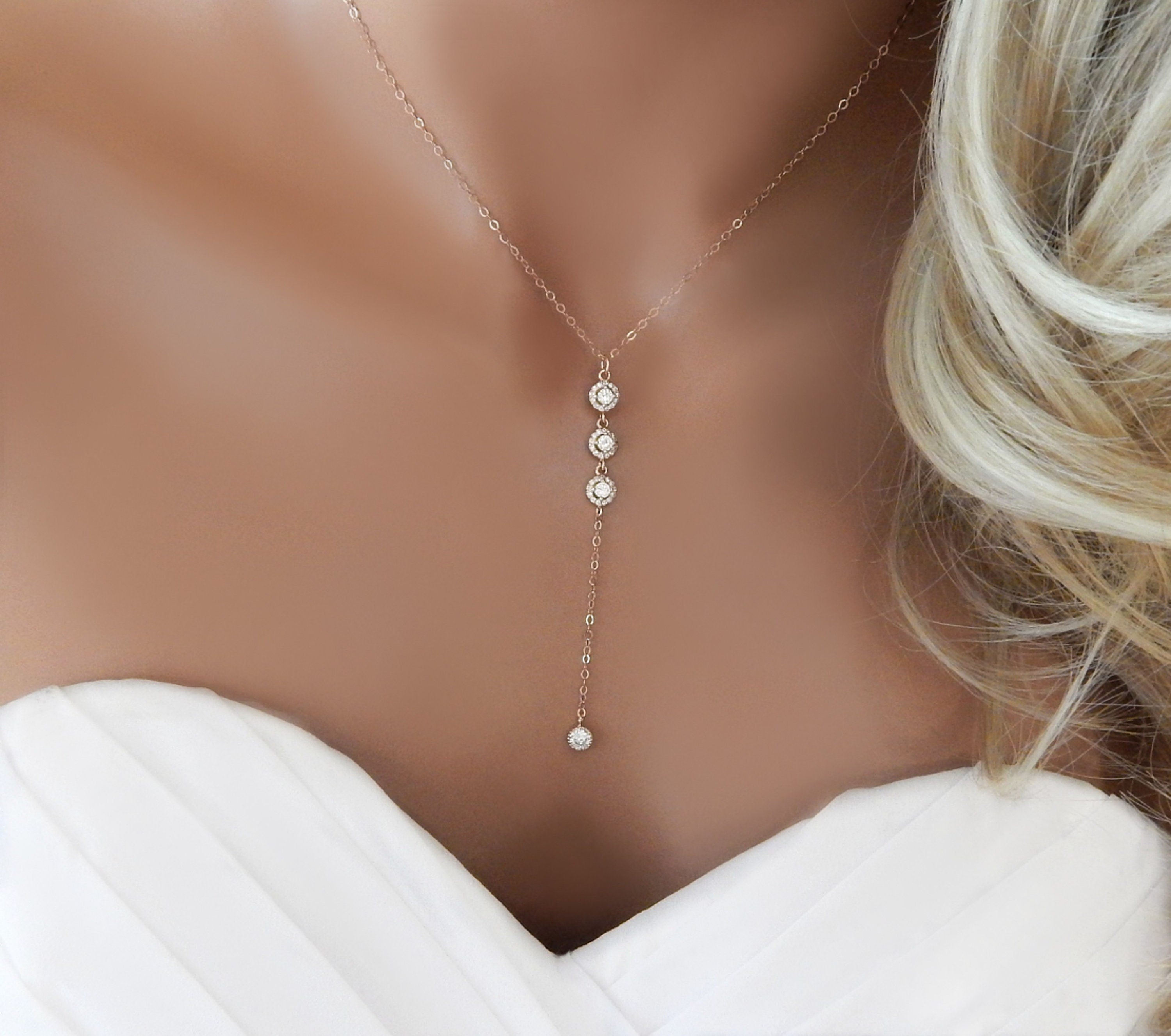 Bridal mannequin torso wearing a rose gold lariat Y necklace with cubic zirconia diamonds.