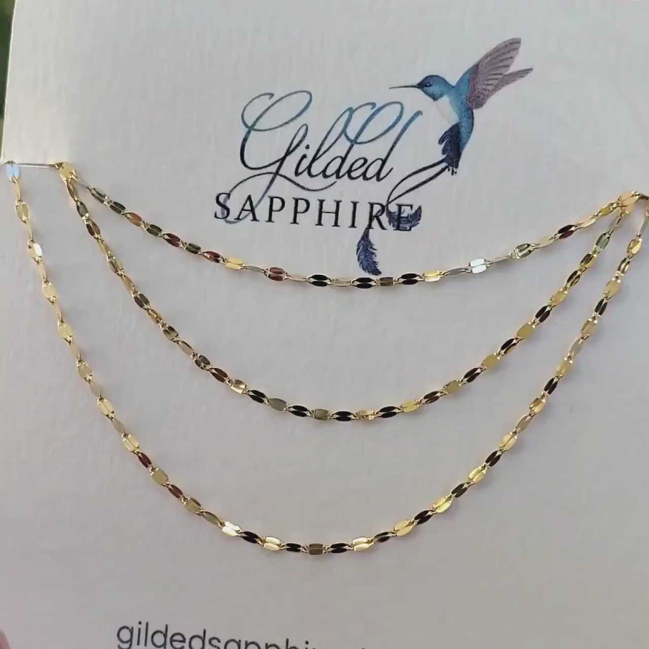 Sequin necklace chain on a necklace card that glimmers and reflects the sunlight.