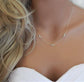 Sterling silver and precious opal necklace on the neck of a mannequin wearing a bridal dress and loose wavy hairstyle.