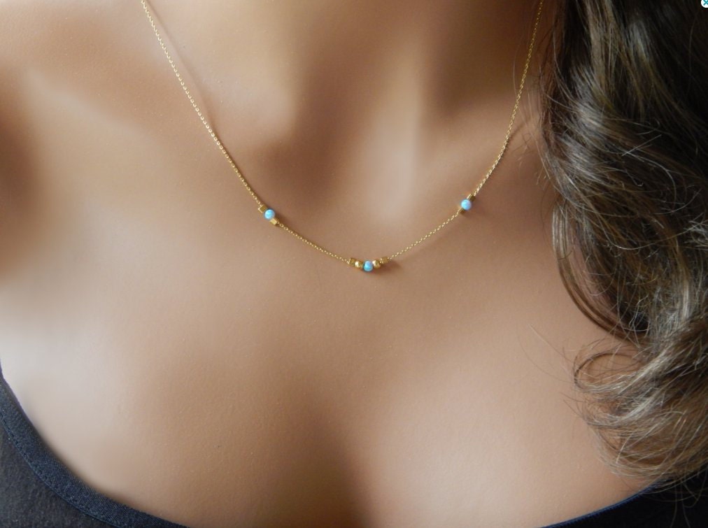 Gold Filled necklace with 3 stationary opals handcrafted by Gilded Sapphire on a mannequin.