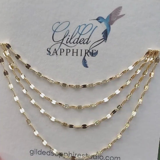 Sequin necklace chain on a necklace card that glimmers and reflects the sunlight.